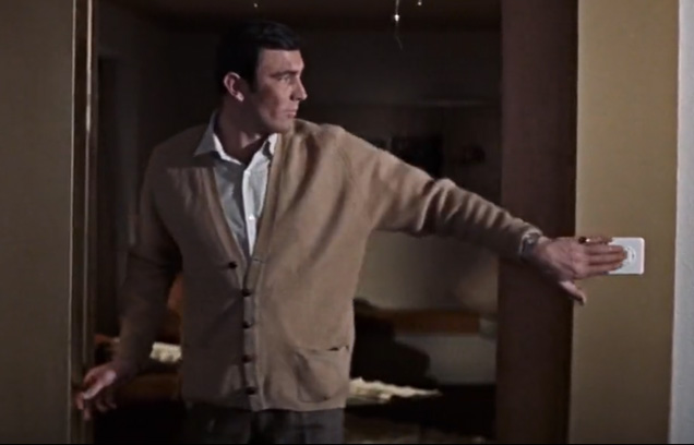 photo © United Artists, Danjaq LLC George Lazenby as James Bond wearing a light brown cardigan with two front pockets in On Her Majesty's Secret Service