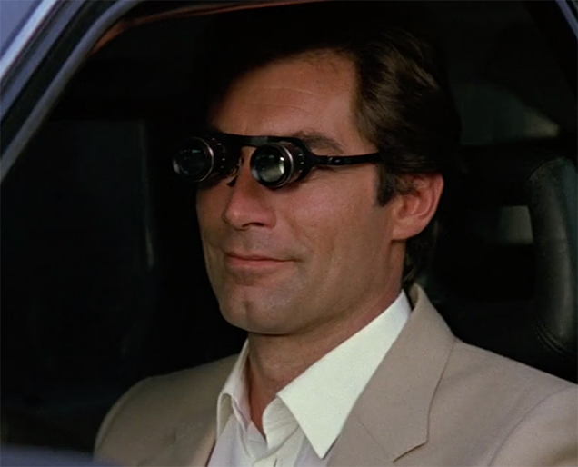 photo © Danjaq LLC, MGM, United Artists Timothy Dalton as James Bond uses a pair of Binocular Glasses in The Living Daylights